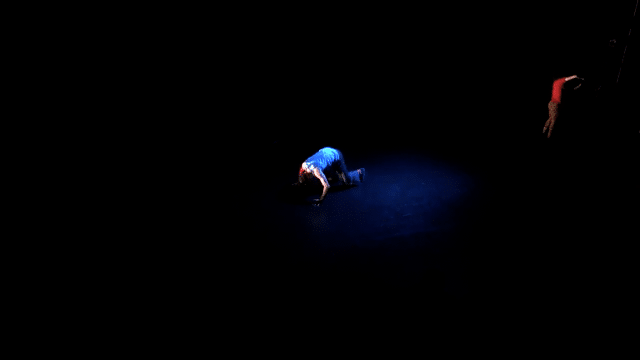 An animated image of dancer Alex Gossen performing on stage in Behan's piece 'Pxyxl' in 2016. The movement shows fast-moving breakdance floorwork or downrocks.