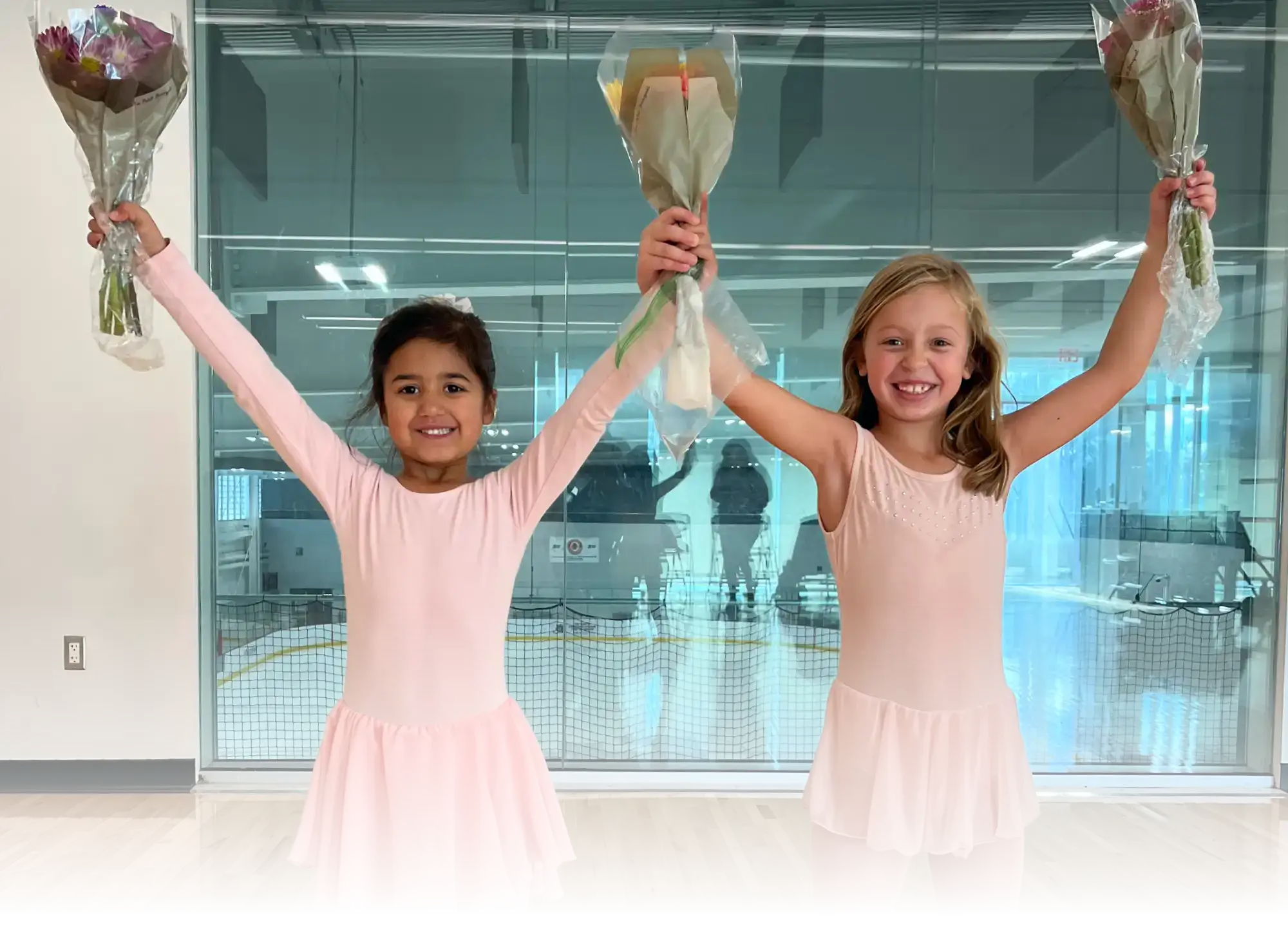 Two young ballet dancers celebrate their end of session informal performance inside the dance studio at the Robert Crown Community Center.